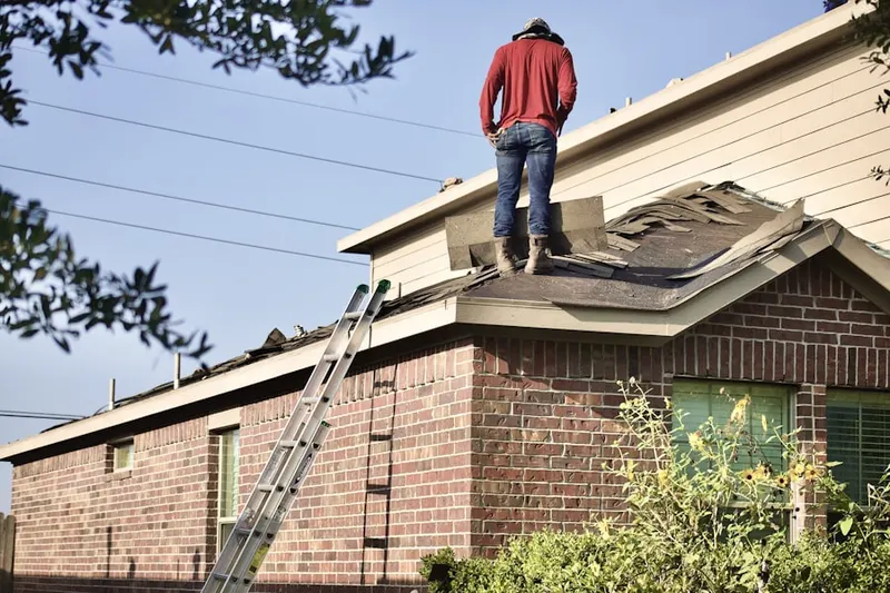 Professional roofer working on a residential roof in Dunnigan